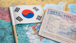 South Korean flag beside a Korea visa document on a map, representing the South Korean Digital Nomad Visa application process.
